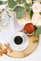 Blush wedding bouquet with roses on gold tray with coffee