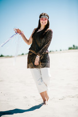 Beautiful stylish sexy young girl with a glass of wine, champagne in sand, beach in the nature. Style boho. Party. Maiden evening Hen-parties. Bachelorette. In pink glasses. Close up.
