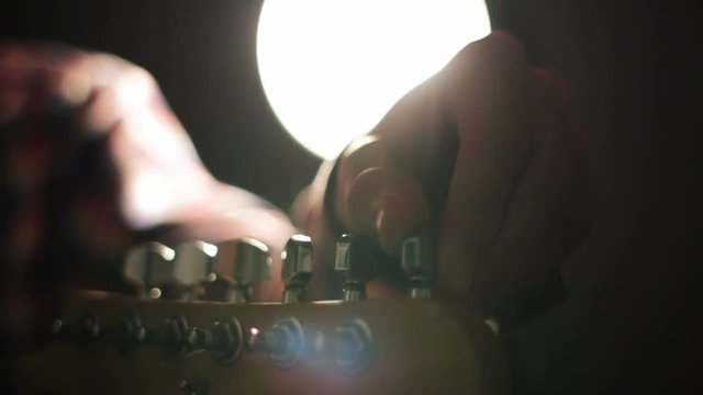 Guitarist sets up the electric guitar before the concert