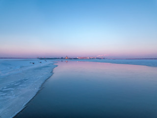 city ​​view from a bird's eye view to a winter city at dawn in the fog