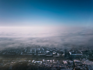 city ​​view from a bird's eye view to a winter city at dawn in the fog