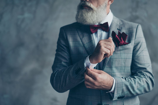 Cropped close up photo of chic virile luxurious trendy wealthy rich sharp well-dressed with burgundy accessories checkered jacket intelligent hipster grandpa fixing cuffs isolated on grey background
