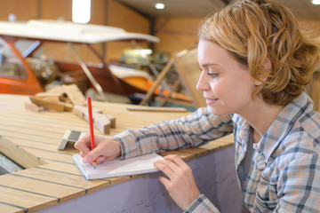female carpenter making notes
