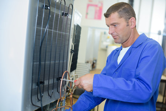 technician fixing an appliance