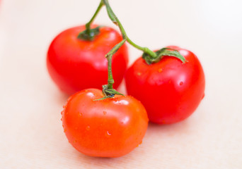 Three red tomatoes with water drops. Fresh vegetables for a healthy diet