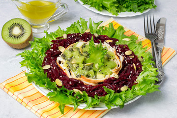 Delicious salad with beets, kiwi and smoked cheese