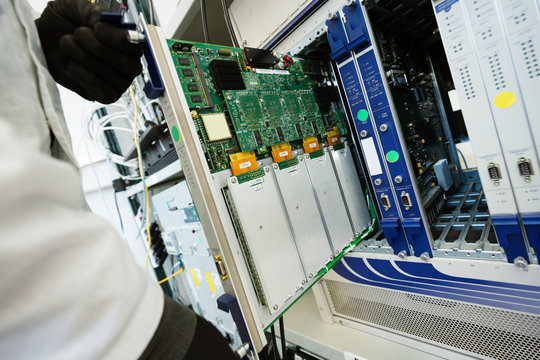Picture of technician repairing cmts networking cards