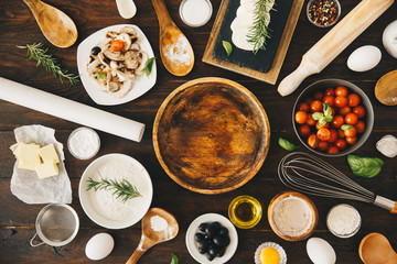 Background with ingredients for pizza on wooden table