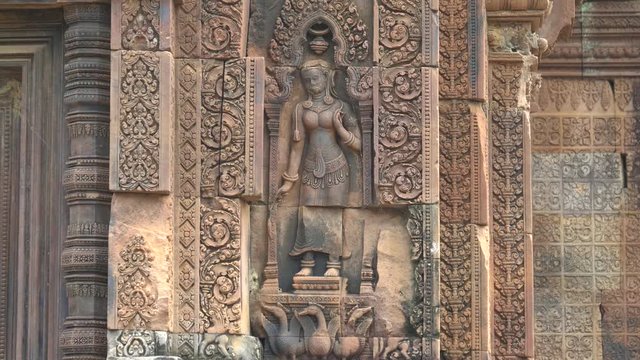 bas relief of a devata in a niche at banteay srei temple in angkor, cambodia