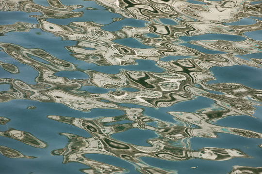Abstract shapes in water - building reflections on sea waves