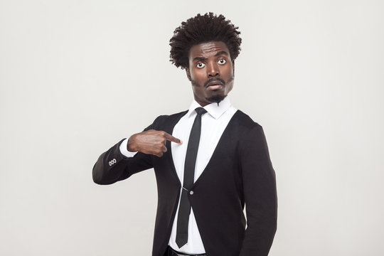 Amazement aloof afro man looking at camera. Studio shot, gray background