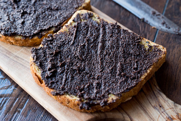 Black Olive Tapenade on Bread with Knife and Jar
