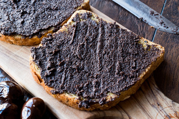Black Olive Tapenade on Bread with Knife and Jar