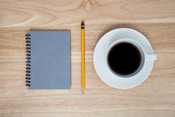 coffee and book on wood table
