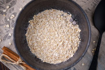 Delicious and healthy breakfast. A bowl with dry flakes of oatmeal.