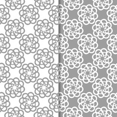 White and gray floral backgrounds. Set of seamless patterns