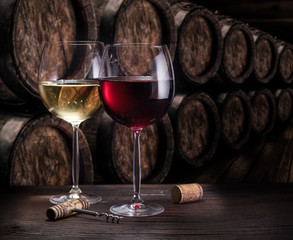 Wine glasses on the old wooden table. Winetasting at the wine cellar.