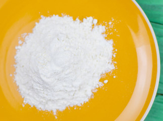 Flour on a yellow plate.