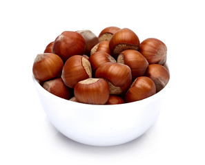 hazelnuts in a bowl on a white background