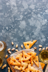 Cheese biscuits, nuts to beer, top view, copy space