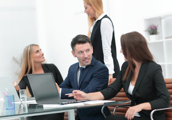 Fototapeta premium business team discussing new information , standing in front of the open laptop
