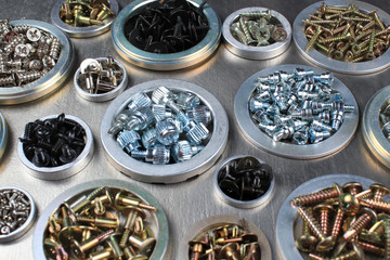 Screws, bolts and nuts on metal background