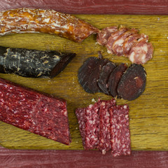 Smoked sausages are cut on a cutting board.