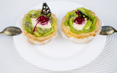 Two cookies - baskets on a white plate.