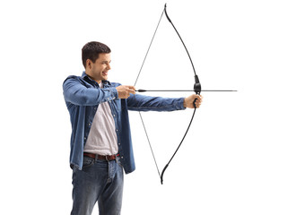 Young man aiming with a bow and arrow