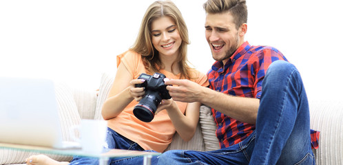 Fototapeta premium happy young couple checks photos on photos the camera