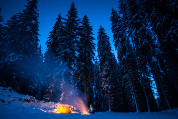winter camping with fire at night