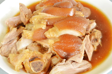 braised pork leg with black Chinese herb soup slice on plate