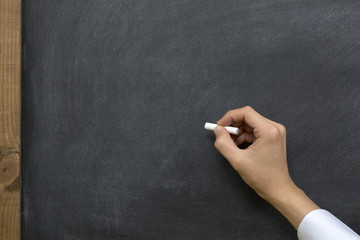Hand writing on chalkboard / blackboard