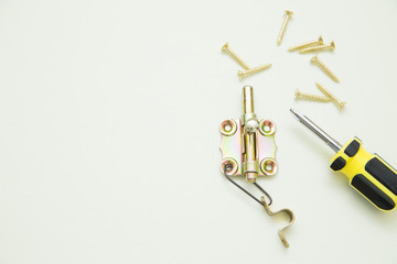 Home, House Repair, Redecorating, Renovating Concept. A set of repair tools on a white grid: screws and screwdriver. Top view, flat lay