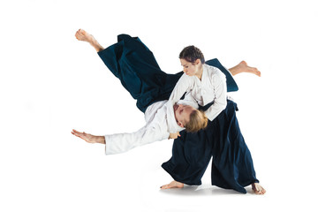 Man and woman fighting at Aikido training in martial arts school - obrazy, fototapety, plakaty
