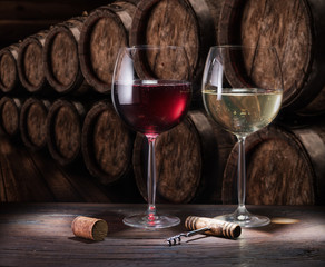 Wine glasses on the old wooden table. Winetasting at the wine cellar.