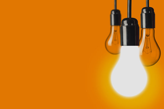 Light bulb on orange background