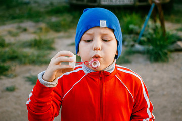 boy inflates soap bubbles
