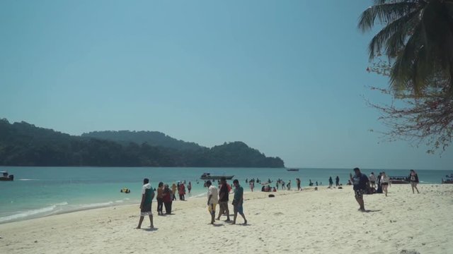 Slow motion tourists walking in Beras Basah Island - Pulau Beras Basah