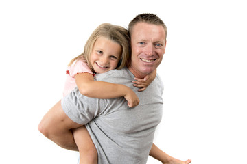 young attractive and happy man carrying his sweet beautiful 7 years old daughter on his back in father and his adorable little girl family love