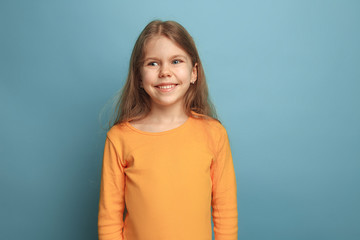 Fototapeta premium The emotional blonde teen girl have a happiness look and toothy smiling. Studio shot
