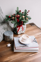 Voronezh/russia-12.28.2017: delicious sweet hot chocolate with marshmallow standing on a pile of books, candles and a winter flower arrangement in a small basket-winter coziness at home