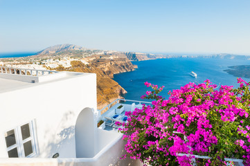 Santorini island, Greece. Beautiful terrace with pink flowers, summer landscape with sea view