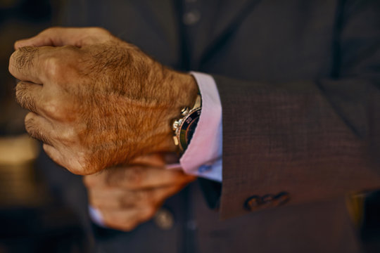 Close-up of man adjusting his cuffs