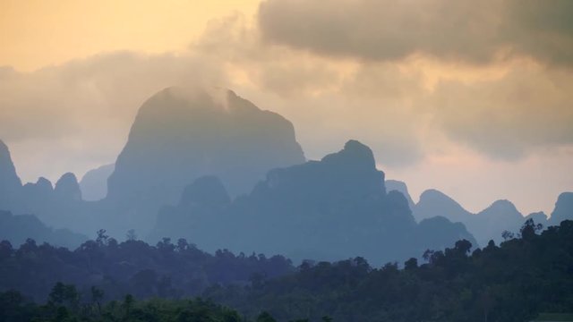 Aerial view of bizarre mountains covered with tropical forest. Sunset cloudy sky. Khao Sok National Park, Thailand