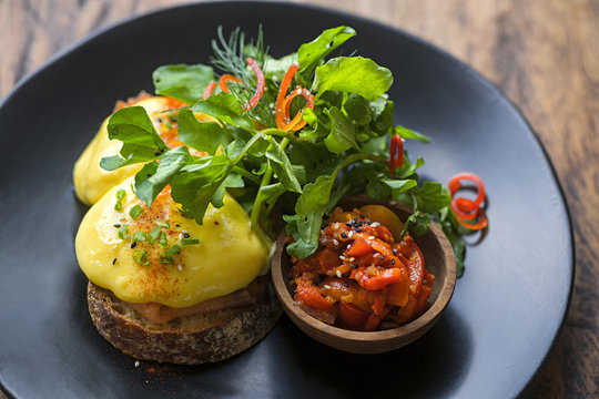 Bread gratinated with cheese with salad and vegetables on plate