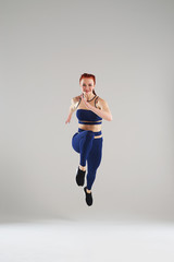 fit woman in blue sportswear running