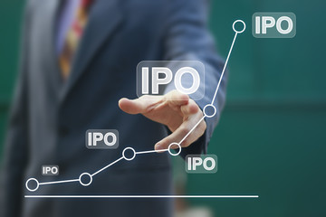 Businessman presses button ipo Initial Public Offering network on chart.
