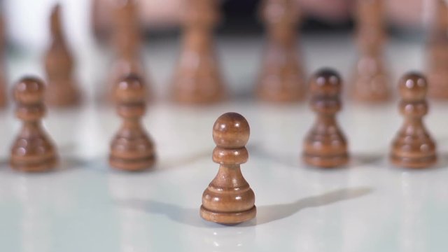 Close up of male hand moving pawn in chess game, business and political strategy