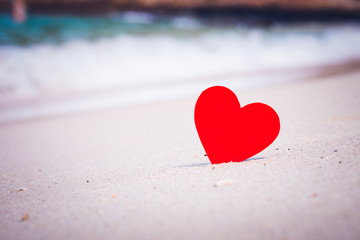 Fototapeta premium Two red hearts on the summer beach. Love, Wedding and Valentines day concept.